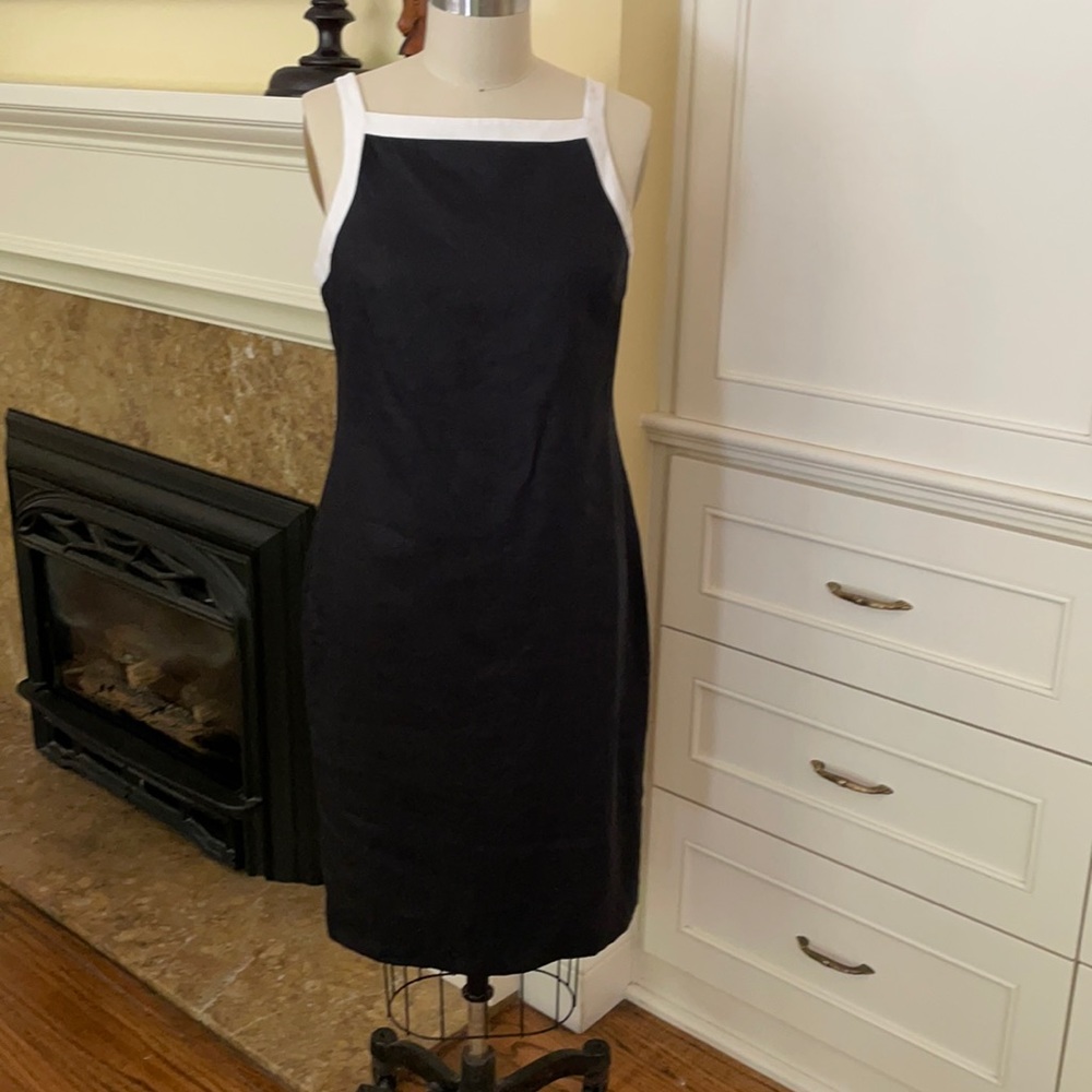 Simple black dress with white trim.